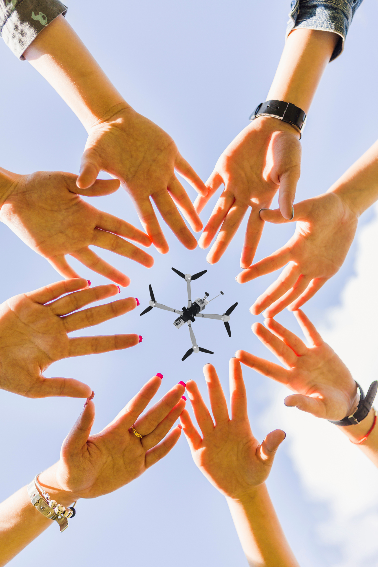 Hands reaching toward a drone